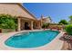 Backyard oasis featuring a sparkling blue swimming pool and spa, surrounded by lush landscaping and a covered patio at 5215 W Del Rio St, Chandler, AZ 85226
