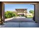 Private backyard featuring a covered patio and lush greenery at 5616 S Caisson Way, Mesa, AZ 85212