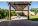 Relaxing backyard patio with a pergola shading comfortable seating and a view of the well maintained yard at 5616 S Caisson Way, Mesa, AZ 85212