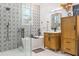 This bathroom features white shiplap walls, marble countertop, a tub, and a shower behind clear glass at 5616 S Caisson Way, Mesa, AZ 85212
