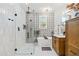 This bathroom has a walk-in shower, dual vanities, shiplap walls, and black hardware throughout at 5616 S Caisson Way, Mesa, AZ 85212