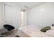 This bedroom offers carpet, neutral walls, a modern chair, and access to another room through a sliding door at 5616 S Caisson Way, Mesa, AZ 85212