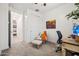 Bright bedroom featuring a chair, ottoman, a desk and a closet at 5616 S Caisson Way, Mesa, AZ 85212