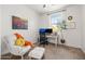 Cozy room featuring a desk, chair, ottoman, and a large window for lots of sunlight at 5616 S Caisson Way, Mesa, AZ 85212