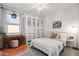 Bright bedroom with a bed, ample storage, a desk, and a large window at 5616 S Caisson Way, Mesa, AZ 85212