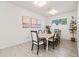 Bright dining room with neutral walls, recessed lighting, a modern chandelier and a sunlit window at 5616 S Caisson Way, Mesa, AZ 85212