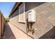 Exterior wall of home on a paved walkway next to a tankless water heater at 5616 S Caisson Way, Mesa, AZ 85212