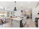 Open-concept kitchen with island seating flows into the living and dining areas at 5616 S Caisson Way, Mesa, AZ 85212