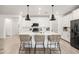 Bright kitchen featuring a large island, modern pendant lighting, and white cabinetry at 5616 S Caisson Way, Mesa, AZ 85212