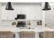 Close-up of a kitchen island with a sink, black appliances, and subway tile backsplash at 5616 S Caisson Way, Mesa, AZ 85212