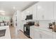 Bright kitchen features white cabinets and countertops with modern black appliances at 5616 S Caisson Way, Mesa, AZ 85212