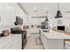 Spacious kitchen with white cabinetry, a center island, and modern stainless steel appliances at 5616 S Caisson Way, Mesa, AZ 85212