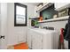 Bright laundry room with modern washer and dryer and lots of storage at 5616 S Caisson Way, Mesa, AZ 85212