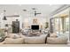 Open-concept living room with bright decor, a ceiling fan and sliding glass doors to the backyard at 5616 S Caisson Way, Mesa, AZ 85212