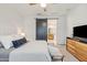 This main bedroom boasts plush carpeting, a ceiling fan, ensuite bathroom access, and modern minimalist decor at 5616 S Caisson Way, Mesa, AZ 85212