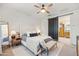 This main bedroom features plush carpeting, a ceiling fan, ensuite bathroom access, and an accent rug at 5616 S Caisson Way, Mesa, AZ 85212