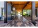 A covered walkway features decorative tiling, exposed beams, and hanging lights at 5616 S Caisson Way, Mesa, AZ 85212