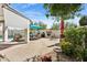 A spacious backyard featuring a luxurious outdoor kitchen, dining area, and sparkling pool at 5909 W Blue Sky Dr, Phoenix, AZ 85083