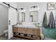 Modern bathroom with a double vanity, marble countertops, and stylish mirrors at 5909 W Blue Sky Dr, Phoenix, AZ 85083