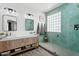 Charming bathroom with a wooden vanity, tiled shower, and contemporary lighting at 5909 W Blue Sky Dr, Phoenix, AZ 85083