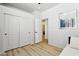 A comfortable bedroom with wood flooring, large closet, and an attached bathroom at 5909 W Blue Sky Dr, Phoenix, AZ 85083