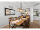 Charming dining room with a wooden table and a stylish light fixture at 5909 W Blue Sky Dr, Phoenix, AZ 85083
