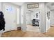 Hallway leading to an office showcases tiled floors, white trim, and modern interior doors at 5909 W Blue Sky Dr, Phoenix, AZ 85083