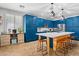 Lovely kitchen featuring blue cabinets, stainless steel appliances, a central island with a wooden base and barstool seating at 5909 W Blue Sky Dr, Phoenix, AZ 85083