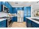 Well-appointed kitchen showcasing blue cabinets, stainless steel appliances, and ample counter space at 5909 W Blue Sky Dr, Phoenix, AZ 85083