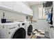 Laundry room featuring modern washer and dryer units and lots of cabinet space at 5909 W Blue Sky Dr, Phoenix, AZ 85083