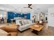 Spacious living room that flows to the kitchen offering a modern island and bar seating at 5909 W Blue Sky Dr, Phoenix, AZ 85083