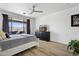 Cozy main bedroom with wood floors, a ceiling fan, and direct access to the backyard at 5909 W Blue Sky Dr, Phoenix, AZ 85083