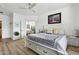 Bright and airy main bedroom featuring wood floors, neutral colors, and ensuite bathroom access at 5909 W Blue Sky Dr, Phoenix, AZ 85083