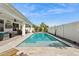 A stunning private pool with a tanning shelf and a partially covered patio in the background at 5909 W Blue Sky Dr, Phoenix, AZ 85083