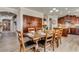 Open-concept dining area with wood floors, adjacent to a modern kitchen and cozy living area at 6528 W Brookhart Way, Phoenix, AZ 85083