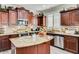 Gourmet kitchen with granite countertops, custom cabinetry, and stainless steel appliances, perfect for cooking at 6528 W Brookhart Way, Phoenix, AZ 85083