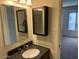 This bathroom features a vanity, mirror, medicine cabinet, and a window offering natural light at 6624 S Granada Dr, Tempe, AZ 85283