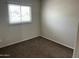 This carpeted bedroom features a window, natural light, and neutral color scheme at 6624 S Granada Dr, Tempe, AZ 85283