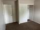 Carpeted bedroom features ample closet space and convenient access to another room at 6624 S Granada Dr, Tempe, AZ 85283