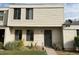 Beige two story home with desert landscaping in front yard and black metal door at 6624 S Granada Dr, Tempe, AZ 85283