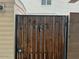 Wooden gate with metal frame and number 6624 painted on the front of the door at 6624 S Granada Dr, Tempe, AZ 85283