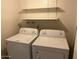 Laundry room with front loading washer and dryer and shelving for storage at 6624 S Granada Dr, Tempe, AZ 85283