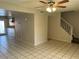 Open living area with tile flooring leading to kitchen and carpeted staircase at 6624 S Granada Dr, Tempe, AZ 85283