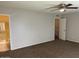 Large primary bedroom featuring a ceiling fan, ensuite bathroom, and neutral tones at 6624 S Granada Dr, Tempe, AZ 85283