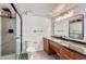 A bathroom featuring a glass-enclosed shower, granite countertops, and modern vanity lighting at 7930 E Camelback Rd # 301, Scottsdale, AZ 85251