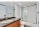 Bathroom featuring granite countertops, a shower with glass doors, and modern fixtures at 7930 E Camelback Rd # 301, Scottsdale, AZ 85251