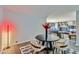 Dining area with a black table, white chairs, and open access to a living space at 7930 E Camelback Rd # 301, Scottsdale, AZ 85251