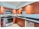 A kitchen featuring stainless steel appliances and dark granite counters, complemented by rich wood cabinetry at 7930 E Camelback Rd # 301, Scottsdale, AZ 85251