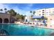 Inviting outdoor pool area with ample seating, palm trees, and clear blue water for relaxation and enjoyment at 7930 E Camelback Rd # 301, Scottsdale, AZ 85251