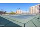 Well-maintained tennis courts surrounded by lush greenery and clear blue skies, perfect for recreational activities at 7930 E Camelback Rd # 301, Scottsdale, AZ 85251